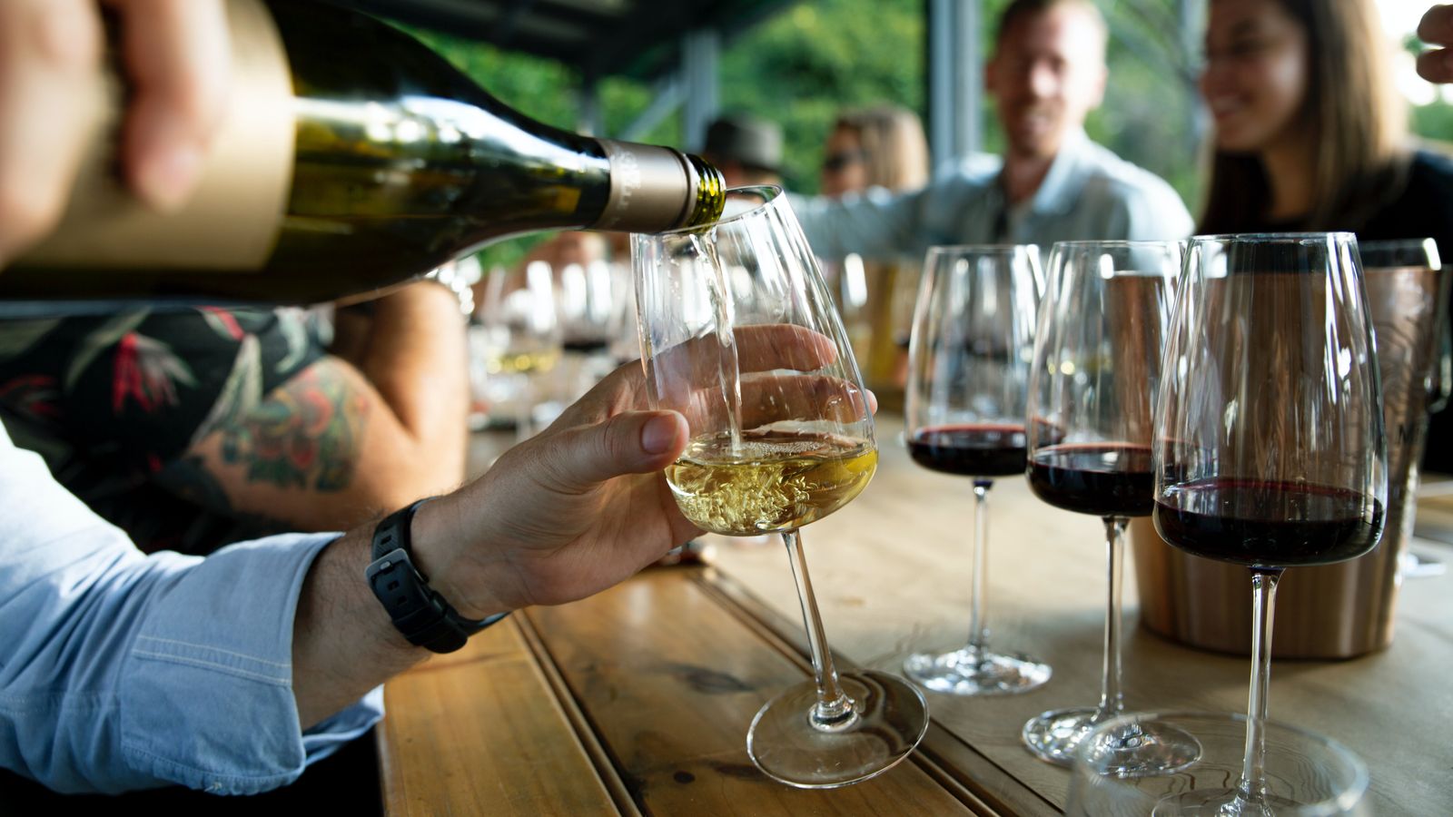 Vinho a ser servido num copo, gesto de prova.